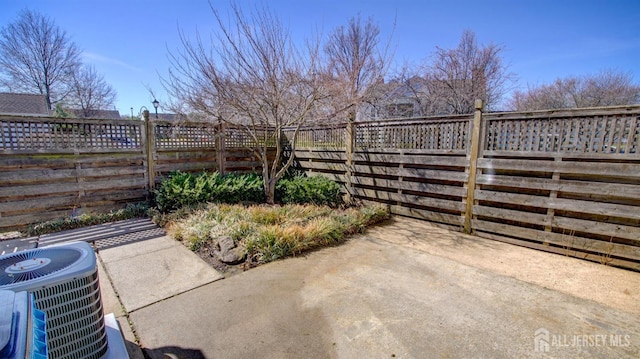 52-C Rutland Ln, Monroe, NJ 08831 - view of patio featuring central AC and a fenced backyard