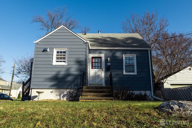 view of front facade with entry steps and a front lawn