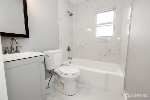 full bathroom with vanity, tiled shower / bath combo, and toilet