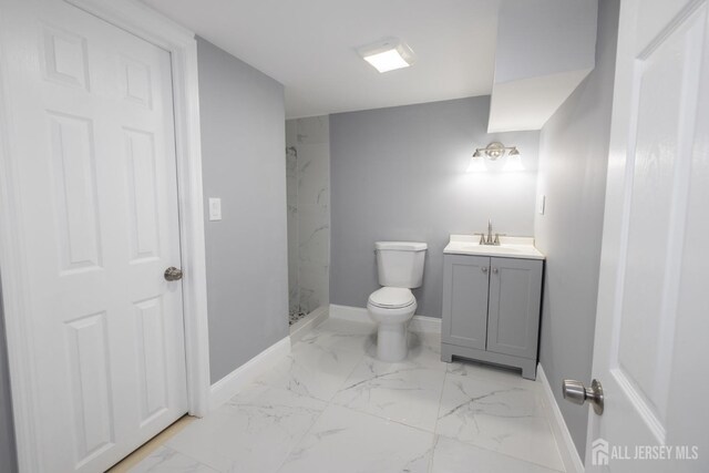 bathroom with vanity, toilet, and a shower