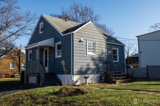 bungalow-style home featuring a front lawn