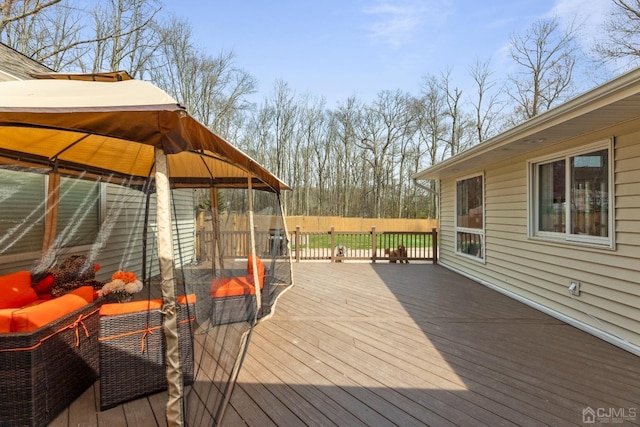 wooden terrace featuring an outdoor living space and a gazebo