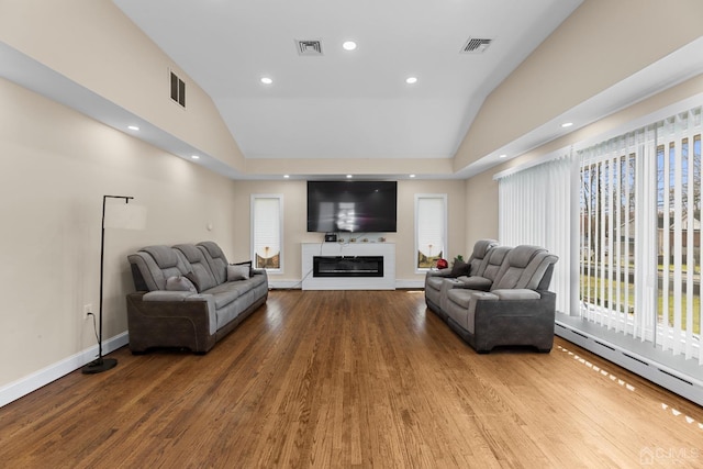 living room featuring lofted ceiling, hardwood / wood-style floors, and a baseboard radiator