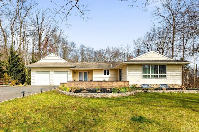 single story home with a garage and a front lawn