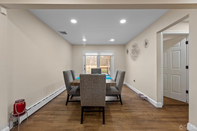 dining space featuring dark hardwood / wood-style flooring and a baseboard radiator