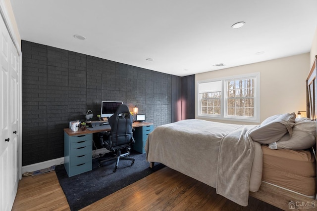 bedroom featuring dark hardwood / wood-style flooring and a closet