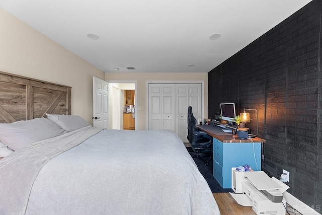 bedroom featuring a closet and dark hardwood / wood-style floors