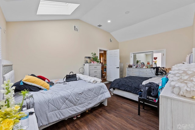 bedroom with dark hardwood / wood-style floors and vaulted ceiling with skylight