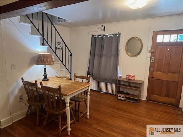 dining space featuring dark hardwood / wood-style floors and radiator heating unit