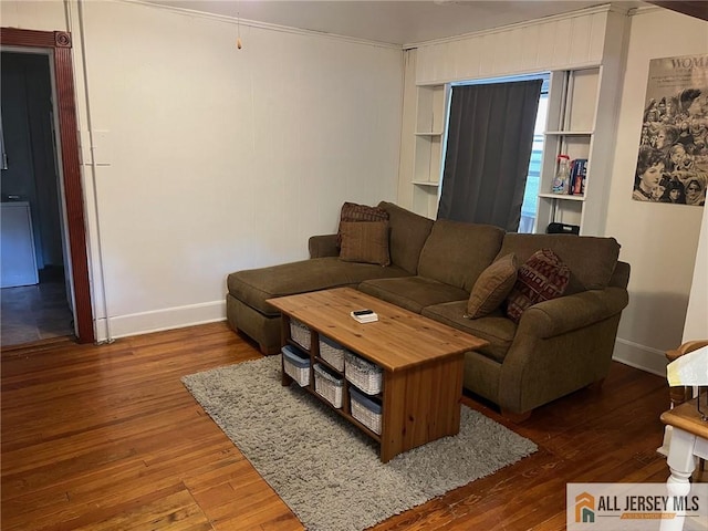 living room featuring ornamental molding and wood-type flooring