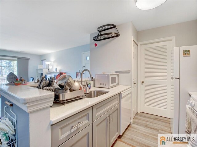 285 Cozzens Ct Unit 285, East Brunswick, NJ 08816 - kitchen featuring white appliances, light countertops, and light wood finished floors