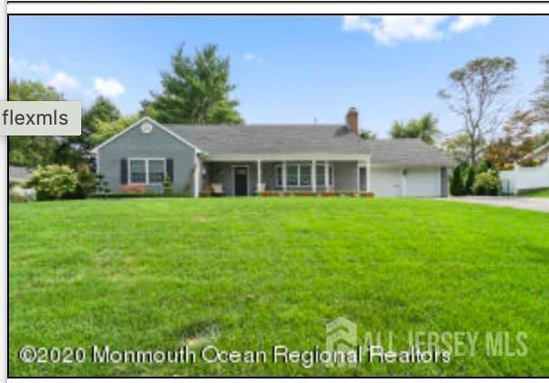 13 Crabtree Rd, Old Bridge, NJ 07747 - view of front of home with concrete driveway, a garage, a front yard, and a chimney