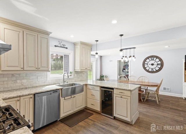 13 Crabtree Rd, Old Bridge, NJ 07747 - kitchen featuring stainless steel dishwasher, beverage cooler, a sink, cream cabinets, and a peninsula