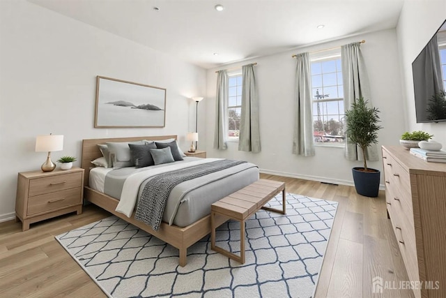 bedroom with recessed lighting, baseboards, and light wood-type flooring