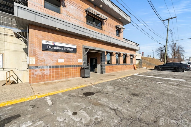 view of building exterior featuring uncovered parking
