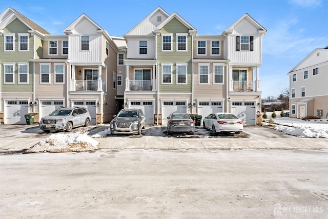70 Depot Way, Dunellen, NJ 08812 - view of property featuring an attached garage, driveway, and board and batten siding