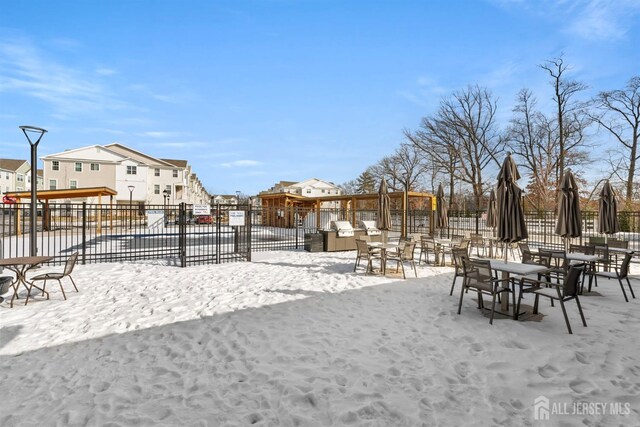 yard covered in snow with fence and a residential view