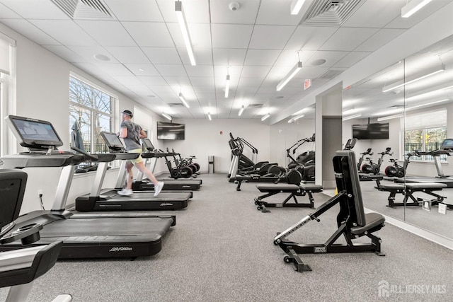 gym featuring a drop ceiling and visible vents