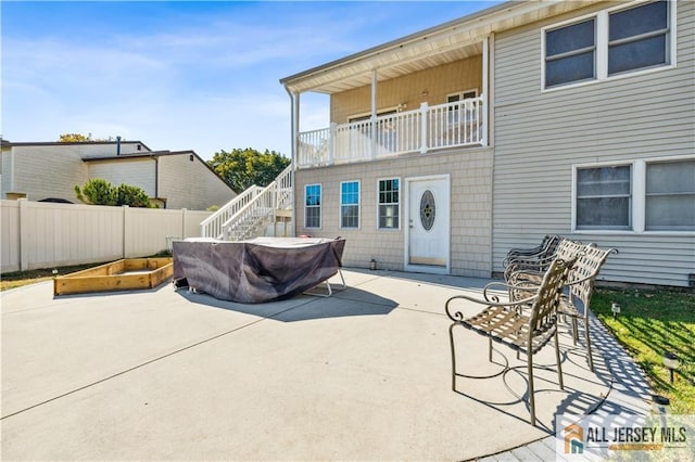 back of house with a patio area and a balcony