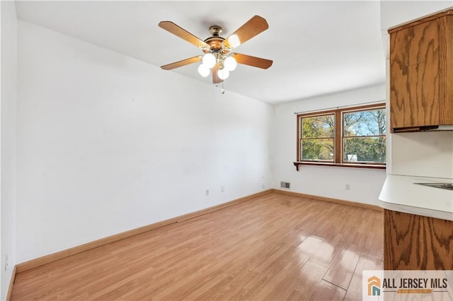 interior space with light hardwood / wood-style floors and ceiling fan