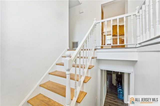 stairs with hardwood / wood-style flooring