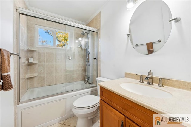 full bathroom featuring vanity, tile patterned flooring, toilet, enclosed tub / shower combo, and ornamental molding