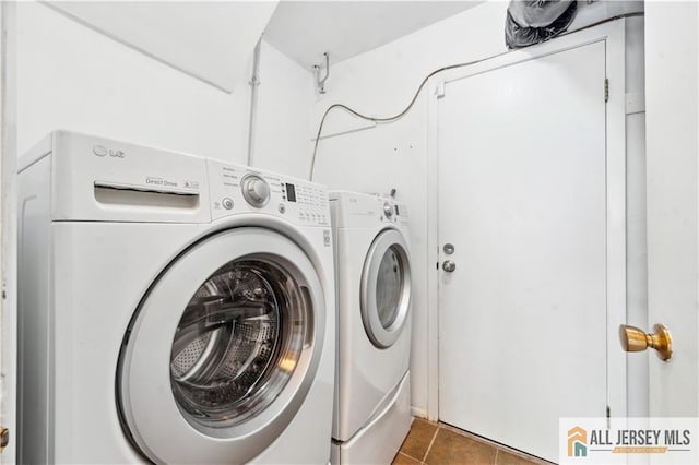 clothes washing area with tile patterned floors and washing machine and clothes dryer