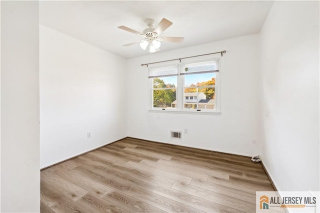 spare room with ceiling fan and light hardwood / wood-style flooring