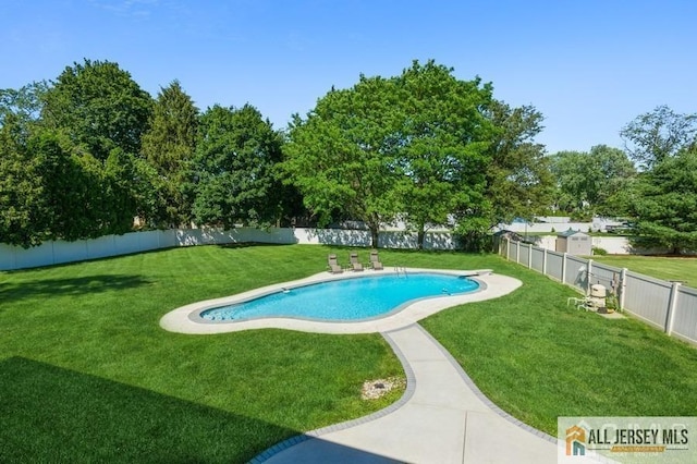 view of swimming pool featuring a yard