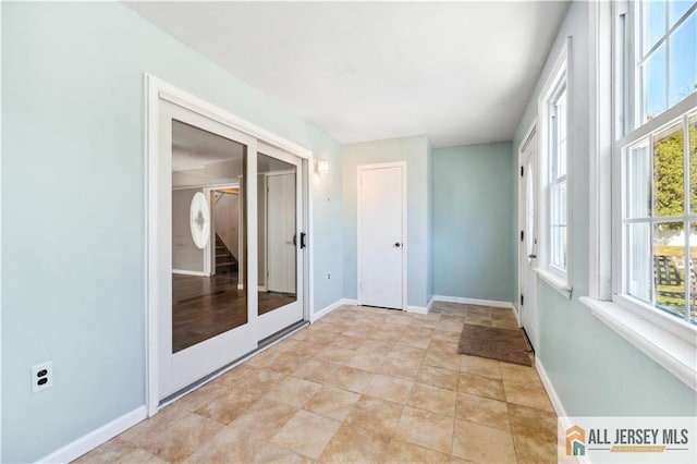 unfurnished sunroom featuring french doors