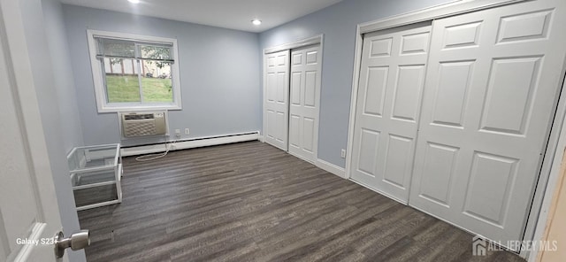 7 Lake Ave Unit Ia, East Brunswick, NJ 08816 - unfurnished bedroom with multiple closets, dark wood-type flooring, recessed lighting, a wall unit AC, and a baseboard radiator