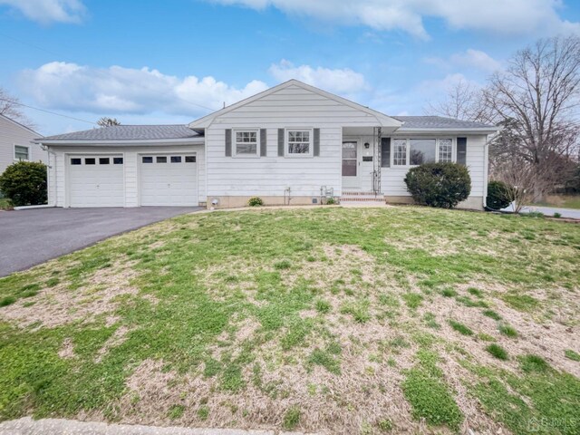 single story home with a garage and a front yard