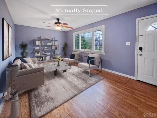 living room featuring ceiling fan and hardwood / wood-style floors