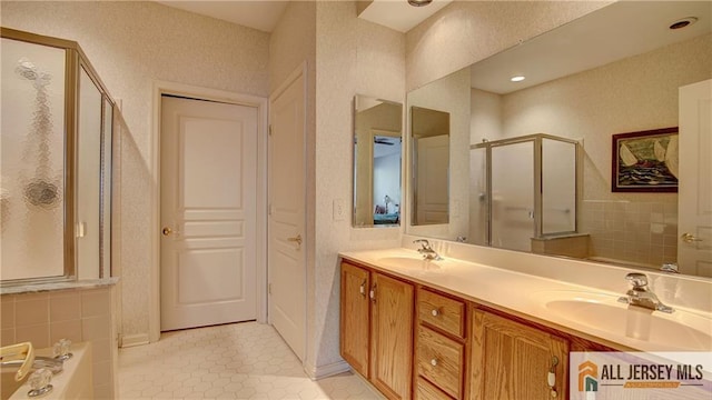 full bathroom with a stall shower, a sink, tile patterned flooring, a bath, and double vanity