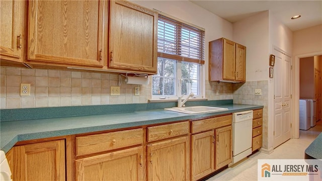 kitchen featuring washer / dryer, tasteful backsplash, dishwasher, a sink, and recessed lighting