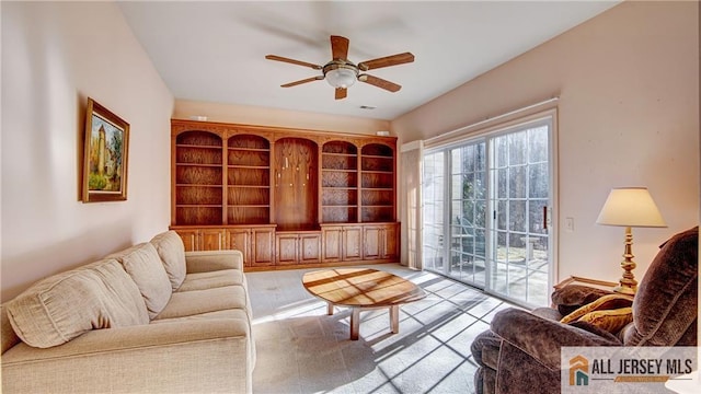 living area with ceiling fan and visible vents