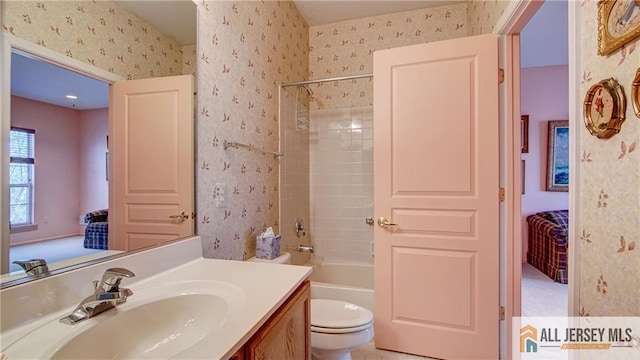 full bathroom with wallpapered walls, toilet, and ensuite bathroom