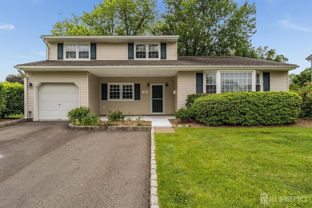 104 Laurel Ave, South Plainfield, NJ 07080 - view of front of property featuring a front yard, an attached garage, and driveway