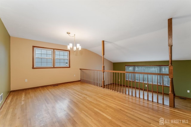 104 Laurel Ave, South Plainfield, NJ 07080 - unfurnished room featuring wood finished floors, a chandelier, and vaulted ceiling