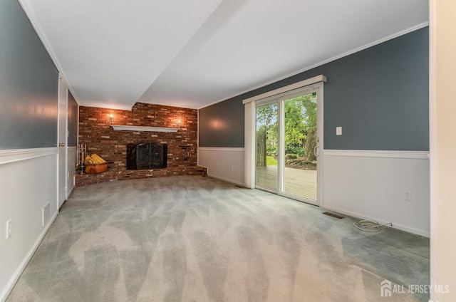 104 Laurel Ave, South Plainfield, NJ 07080 - unfurnished living room featuring a brick fireplace, carpet, wainscoting, and crown molding