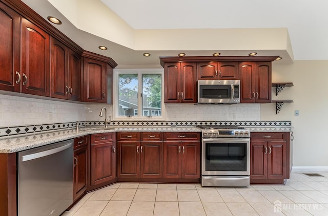 104 Laurel Ave, South Plainfield, NJ 07080 - kitchen featuring stainless steel appliances, light stone countertops, recessed lighting, backsplash, and light tile patterned floors