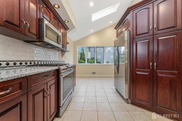 104 Laurel Ave, South Plainfield, NJ 07080 - kitchen with appliances with stainless steel finishes, reddish brown cabinets, lofted ceiling, tasteful backsplash, and light tile patterned floors