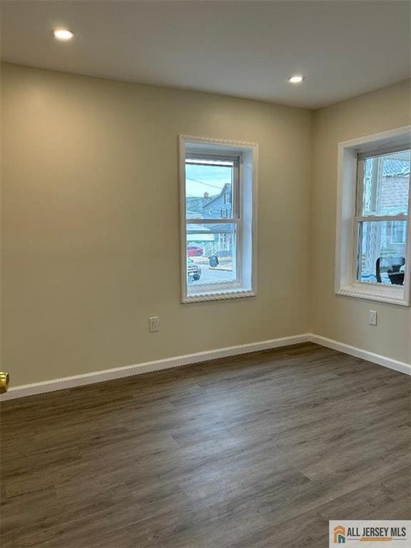 23 June St, South River, NJ 08882 - spare room with healthy amount of natural light, dark wood-style floors, baseboards, and recessed lighting
