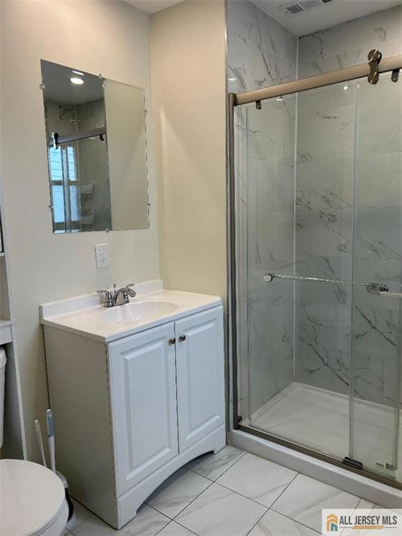 23 June St, South River, NJ 08882 - bathroom with a marble finish shower, marble look tile flooring, toilet, and vanity