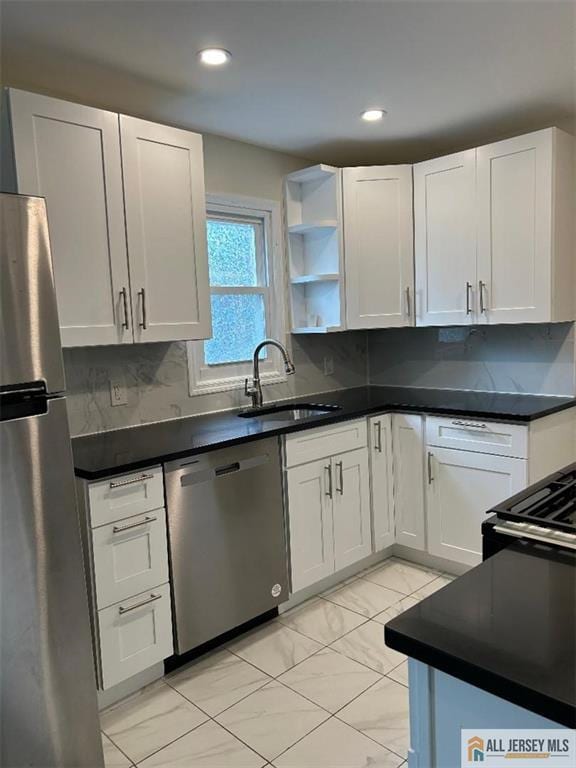 23 June St, South River, NJ 08882 - kitchen featuring appliances with stainless steel finishes, a sink, dark countertops, white cabinets, and recessed lighting