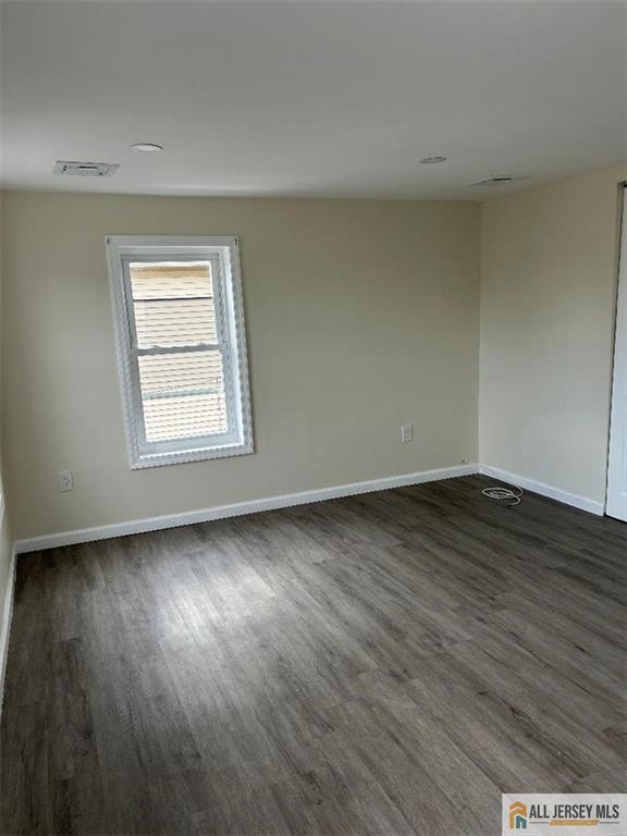 23 June St, South River, NJ 08882 - unfurnished room with dark wood finished floors and baseboards