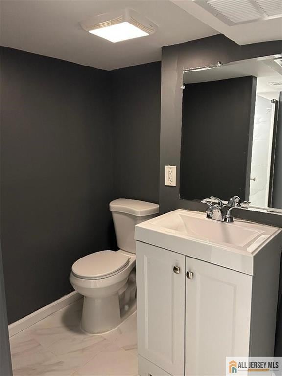 23 June St, South River, NJ 08882 - half bathroom with toilet, marble look tiles, and vanity