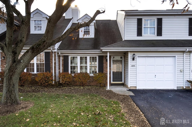 277 Edgeware Ct, Franklin, NJ 08873 - view of front of house with an attached garage, a front lawn, a chimney, and brick siding