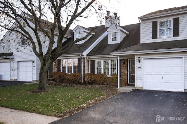 277 Edgeware Ct, Franklin, NJ 08873 - view of front of house with a chimney, asphalt driveway, brick siding, and an attached garage