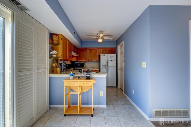 277 Edgeware Ct, Franklin, NJ 08873 - kitchen with white refrigerator with ice dispenser, stainless steel microwave, light countertops, a peninsula, and ceiling fan